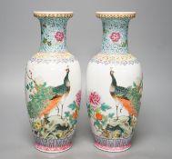 † † A pair of Chinese famille rose vases decorated with peacocks, 31cm