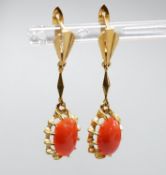 A pair of 18k and oval coral bead set drop earrings, 39mm, gross weight 6.8 grams.