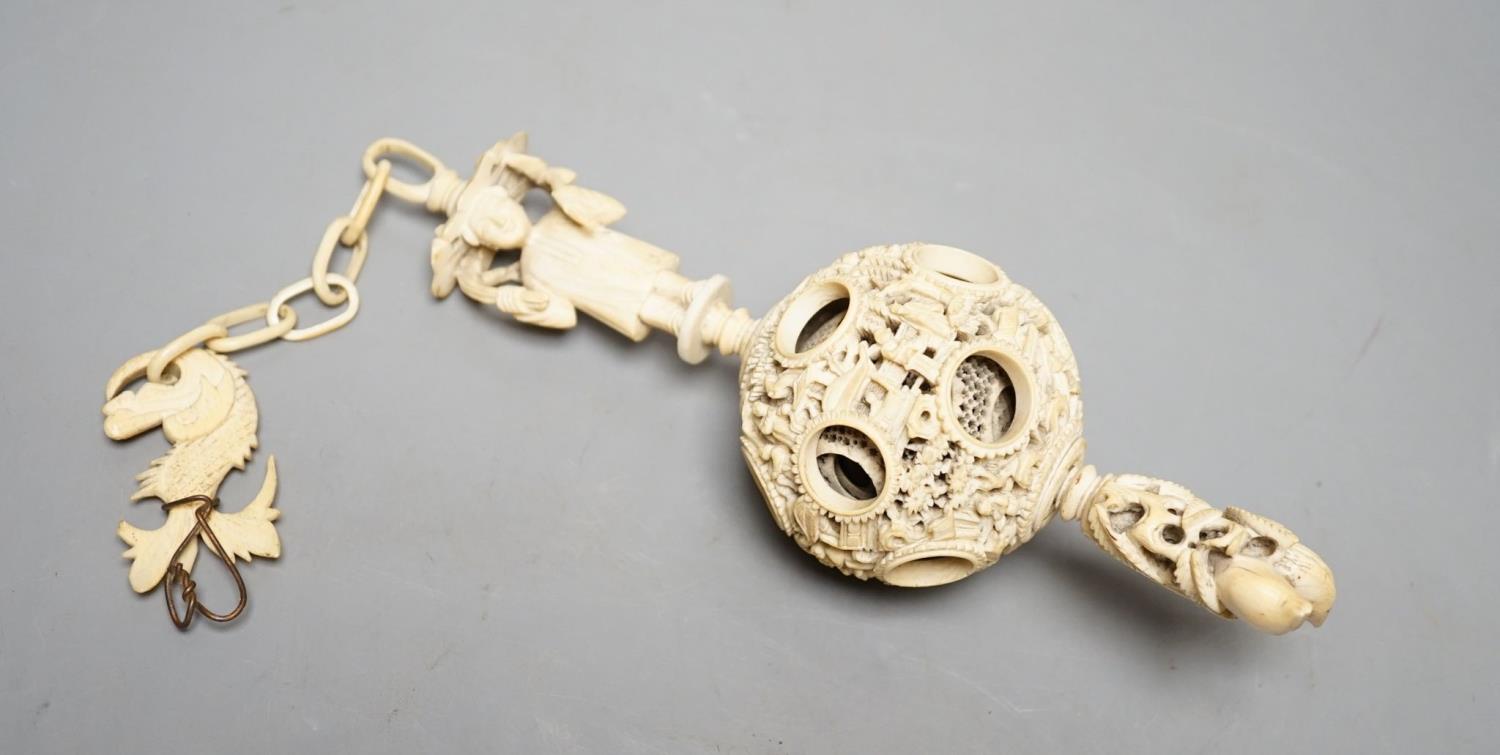A 19th century Chinese export ivory puzzle ball.31 cms long including chain.