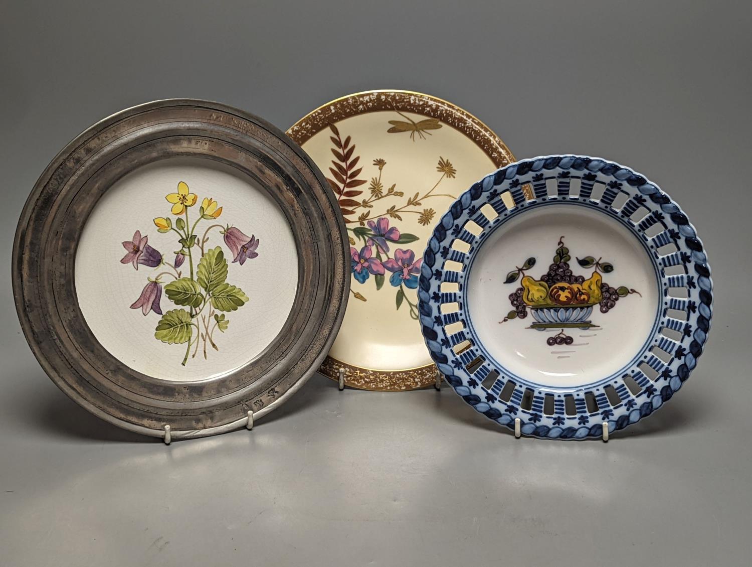 A collection of french pewter and ceramic plates, a set of Dutch fruit plates and a 2 part dessert