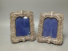 A pair of Edwardian repousse silver mounted photograph frames, Sydney & Co, Birmingham, 1902, 22.5cm