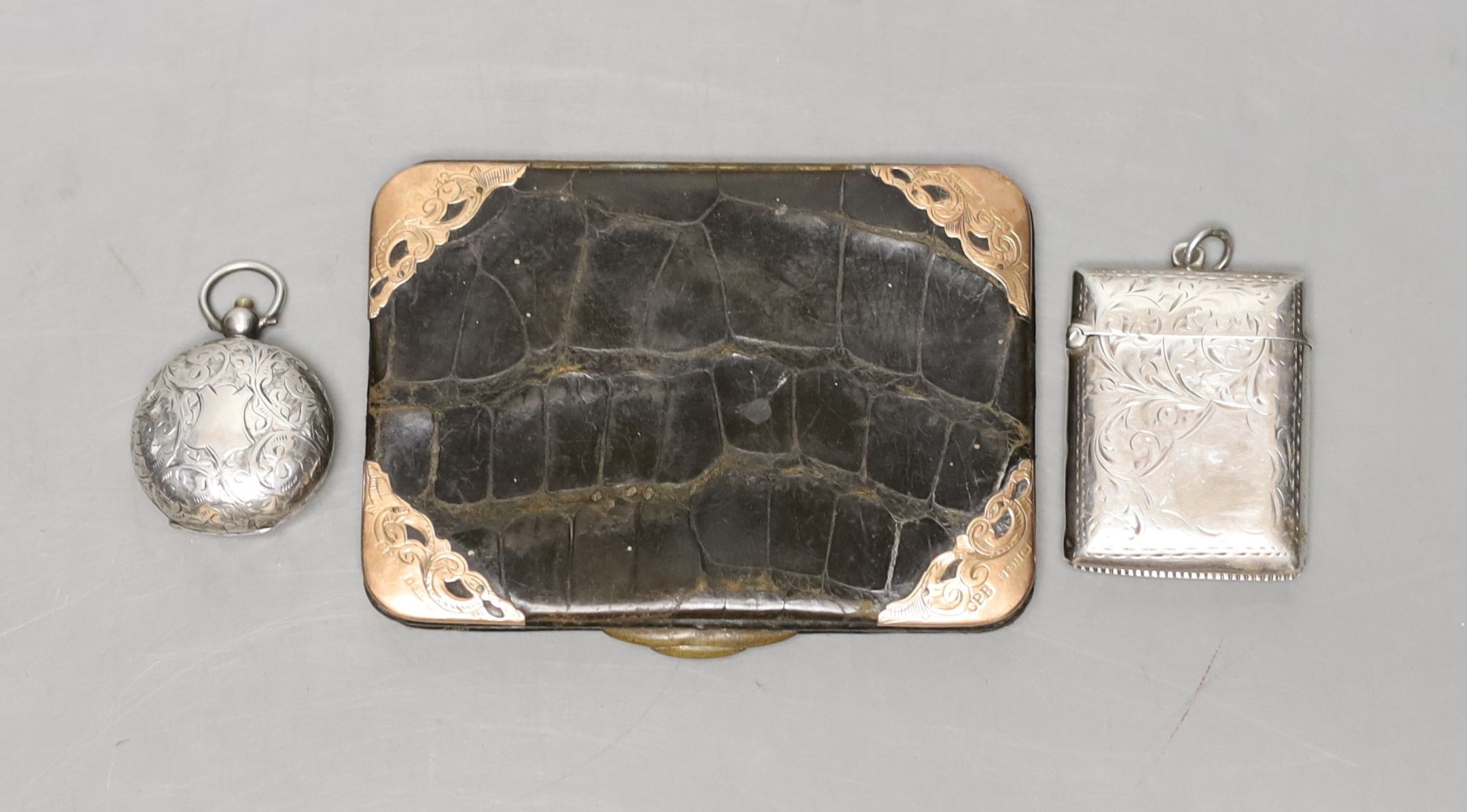 A late Victorian engraved silver sovereign case, a silver vesta case and an Edwardian 9ct gold