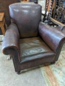 A studded brown leather club armchair, width 86cm, depth 81cm, height 90cm