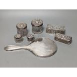 A silver mounted hand mirror, five assorted silver mounted glass toilet jars and an Indian white