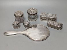 A silver mounted hand mirror, five assorted silver mounted glass toilet jars and an Indian white