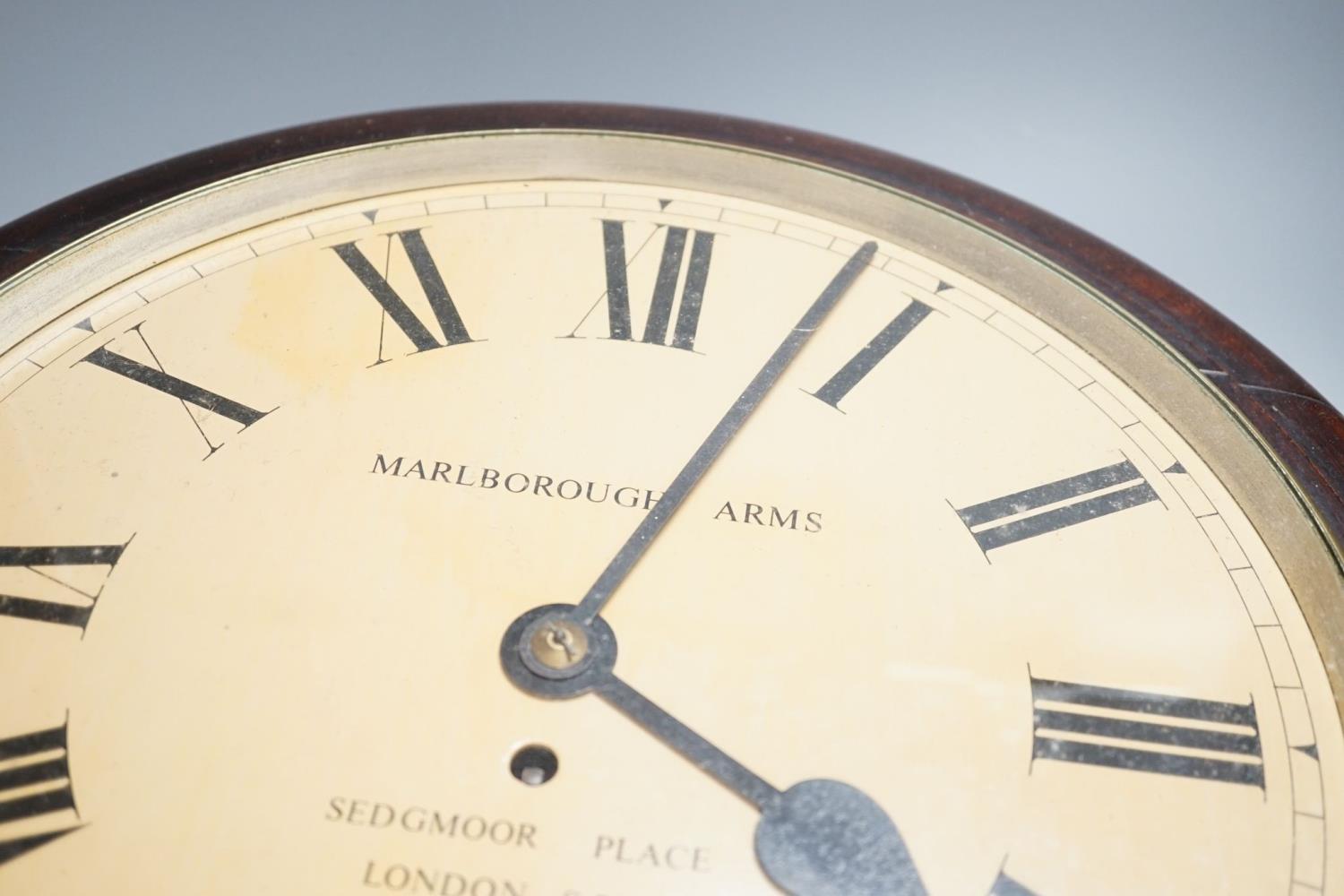 A mahogany dial clock, Marlborough Arms, Sedgmoor Place, London SE5.48 cms diameter. - Image 2 of 2