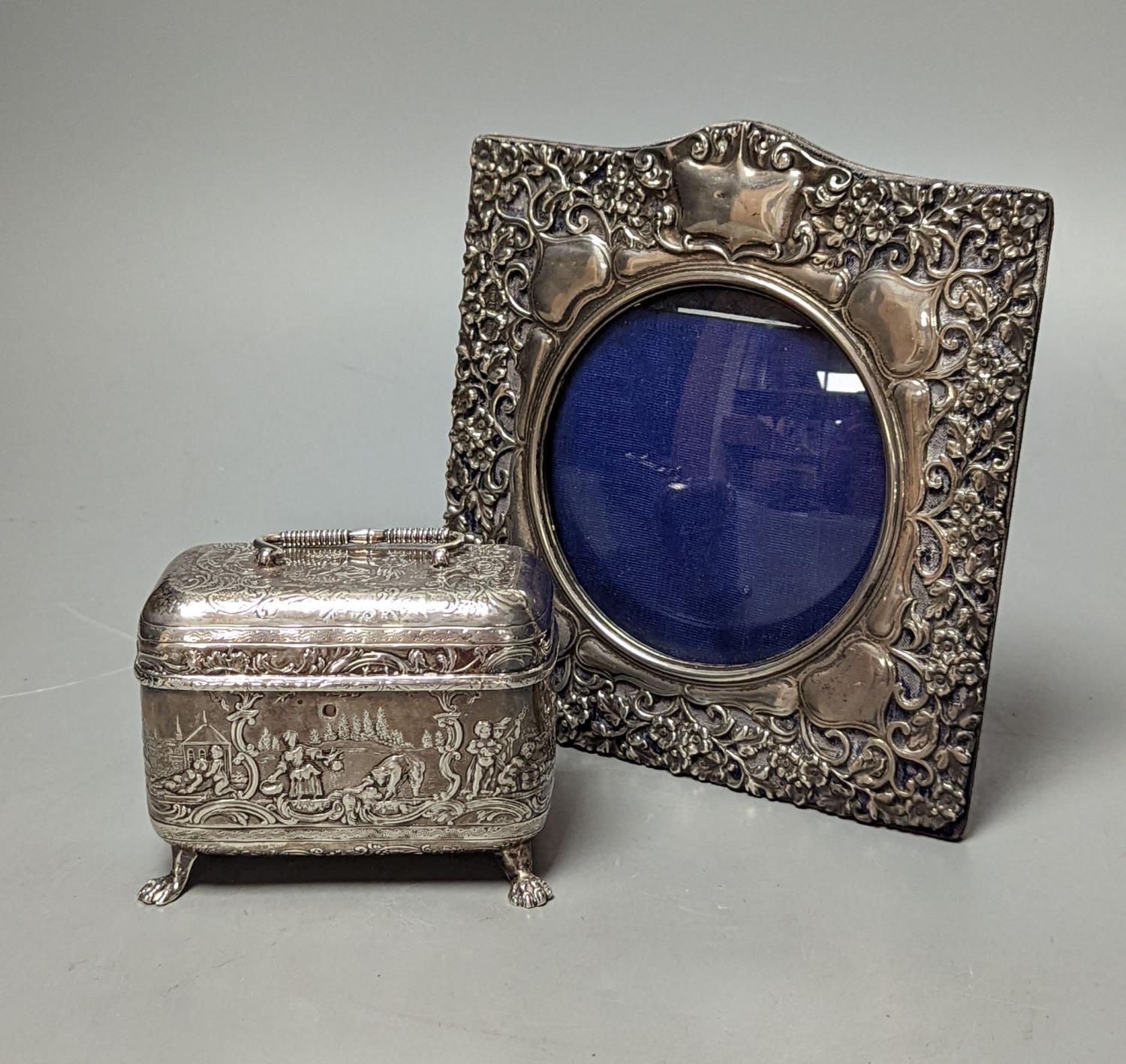 An Edwardian repousse silver mounted photograph frame, Birmingham, 1901, 15.8cm and a small white