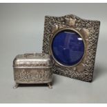 An Edwardian repousse silver mounted photograph frame, Birmingham, 1901, 15.8cm and a small white