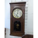 A 1920's oak cased wall clock, height 80cm
