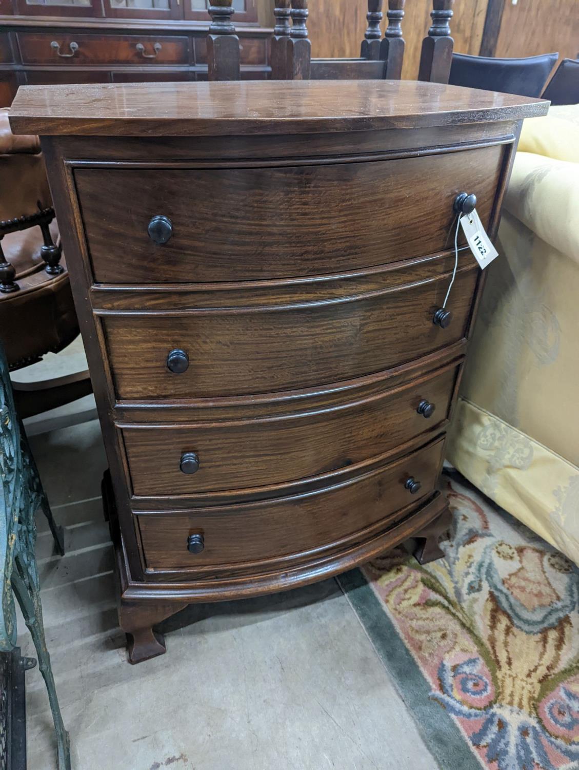 A small reproduction mahogany bow front chest of four long drawers, width 60cm, depth 38cm, height