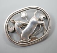 A Georg Jensen sterling 'kneeling deer' oval brooch, no. 256.