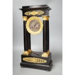 A 19th century ebonised portico mantel clock with brass mounts,46cms high.