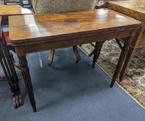 A Regency rosewood brass mounted rectangular folding card table with fluted legs, in the manner of