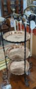 An early 20th century wrought iron and copper three tiered cake stand