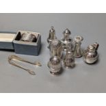 A cased silver napkin ring, seven assorted silver pepperettes including Guernsey can and a pair of