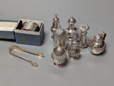 A cased silver napkin ring, seven assorted silver pepperettes including Guernsey can and a pair of