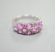 A modern 14k white metal, pink sapphire and diamond cluster set half hoop dress ring, size O,