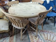 A Victorian style circular pine breakfast table, diameter 105cm, height 74cm, together with four