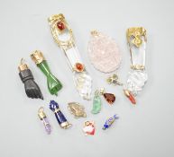 Seven assorted yellow metal or gilt metal mounted clasped hand charm or pendants, largest, 94mm, and