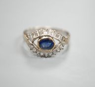 A modern 585 white metal sapphire and baguette cut diamond cluster set 'eye' ring, size T, gross 4