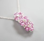 A modern 14k white meta. pink sapphire and diamond cluster set pendant, on a 14k fine link chain(
