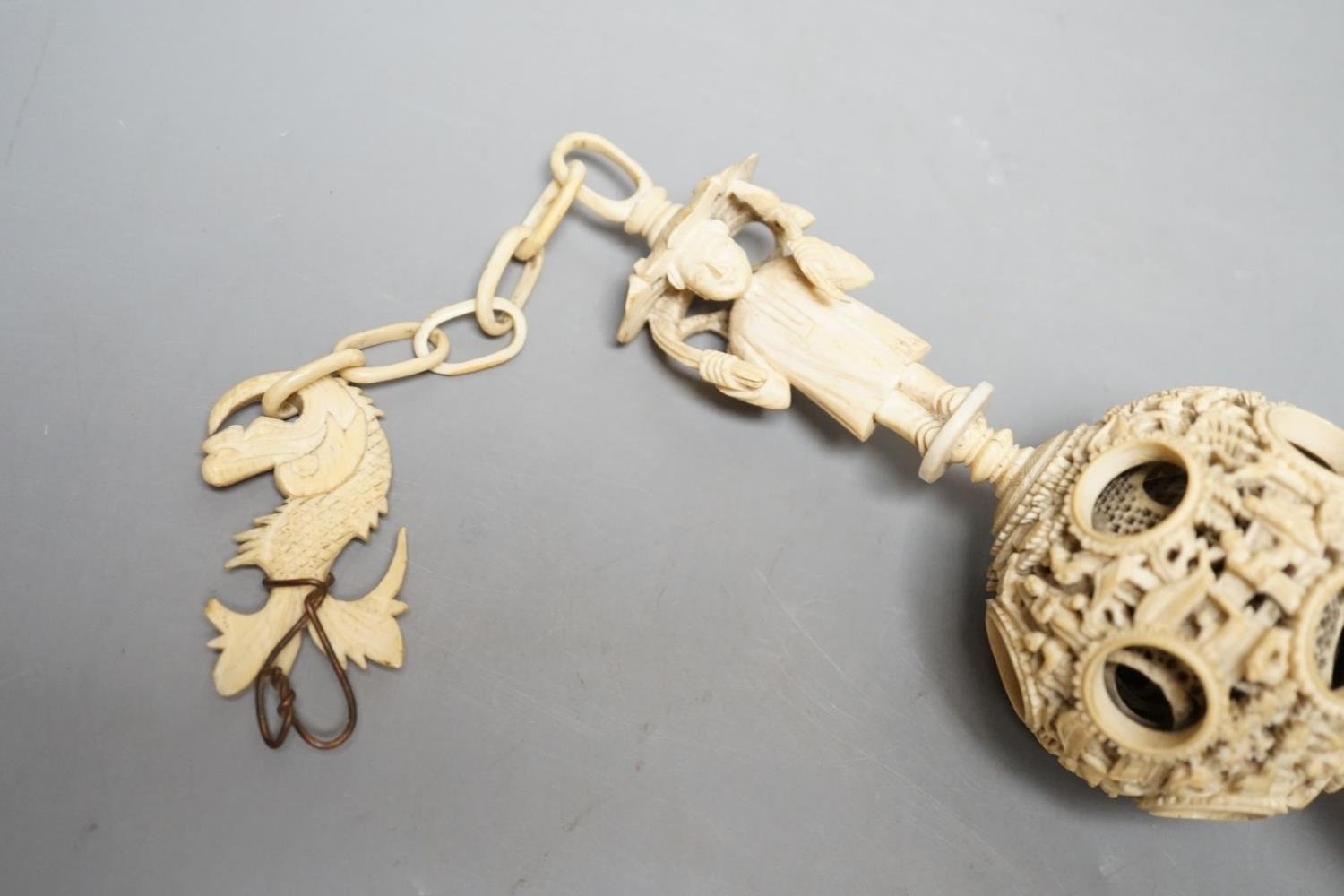 A 19th century Chinese export ivory puzzle ball.31 cms long including chain. - Image 2 of 2