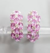 A modern pair of 14k white metal, pink sapphire and diamond cluster set half hoop earrings, 17mm,