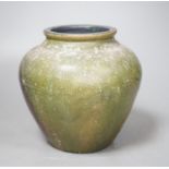 A copper lustre and green glazed pottery jar, 17.5cm high