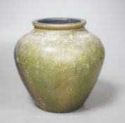 A copper lustre and green glazed pottery jar, 17.5cm high