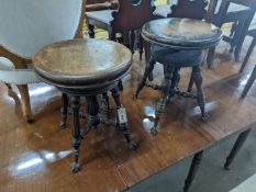 A near pair of Victorian mahogany and beech adjustable stools with revolving seats, larger