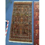 A Bokhara red ground rug, 180 x 126cm and two other rugs