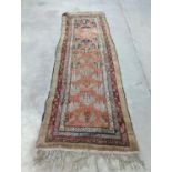 An Afghan brick red ground geometric runner and a smaller Afghan rug, larger 306 x 106cm