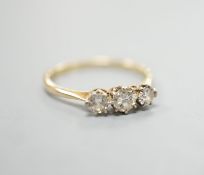 An 18ct and three stone diamond set ring, size P/Q, gross weight 1.7 grams.