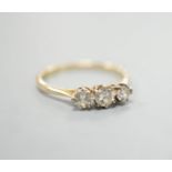 An 18ct and three stone diamond set ring, size P/Q, gross weight 1.7 grams.