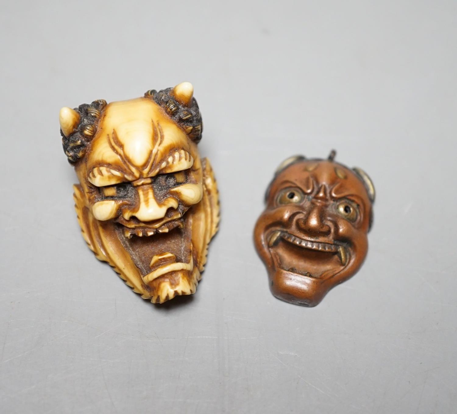 An unusual Japanese mixed metal noh mask containing minute bone dice and a stag antler noh mask
