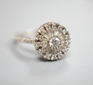 A modern white metal, round and trapeze cut diamond set target cluster ring, with diamond set