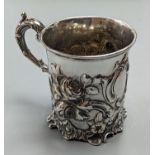 A Victorian embossed silver christening mug, decorated with roses amid scrolls, The Barnards,