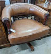 A late Victorian mahogany and tan leather swivel desk chair, width 68cm, depth 63cm, height 77cm