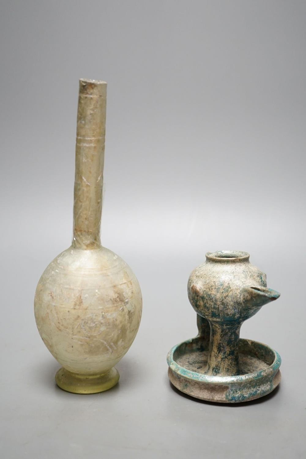 A Kashan oil lamp, 13th/14th century, and an early Islamic glass bottle.Bottle 22 cms high. - Image 2 of 2