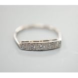 An 18ct and plat, graduated five stone diamond set half hoop ring, size N, gross weight 1.8 grams.