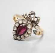 A 19th century yellow metal, garnet and rose cut diamond set heart shaped ring, with ribbon bow