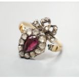 A 19th century yellow metal, garnet and rose cut diamond set heart shaped ring, with ribbon bow