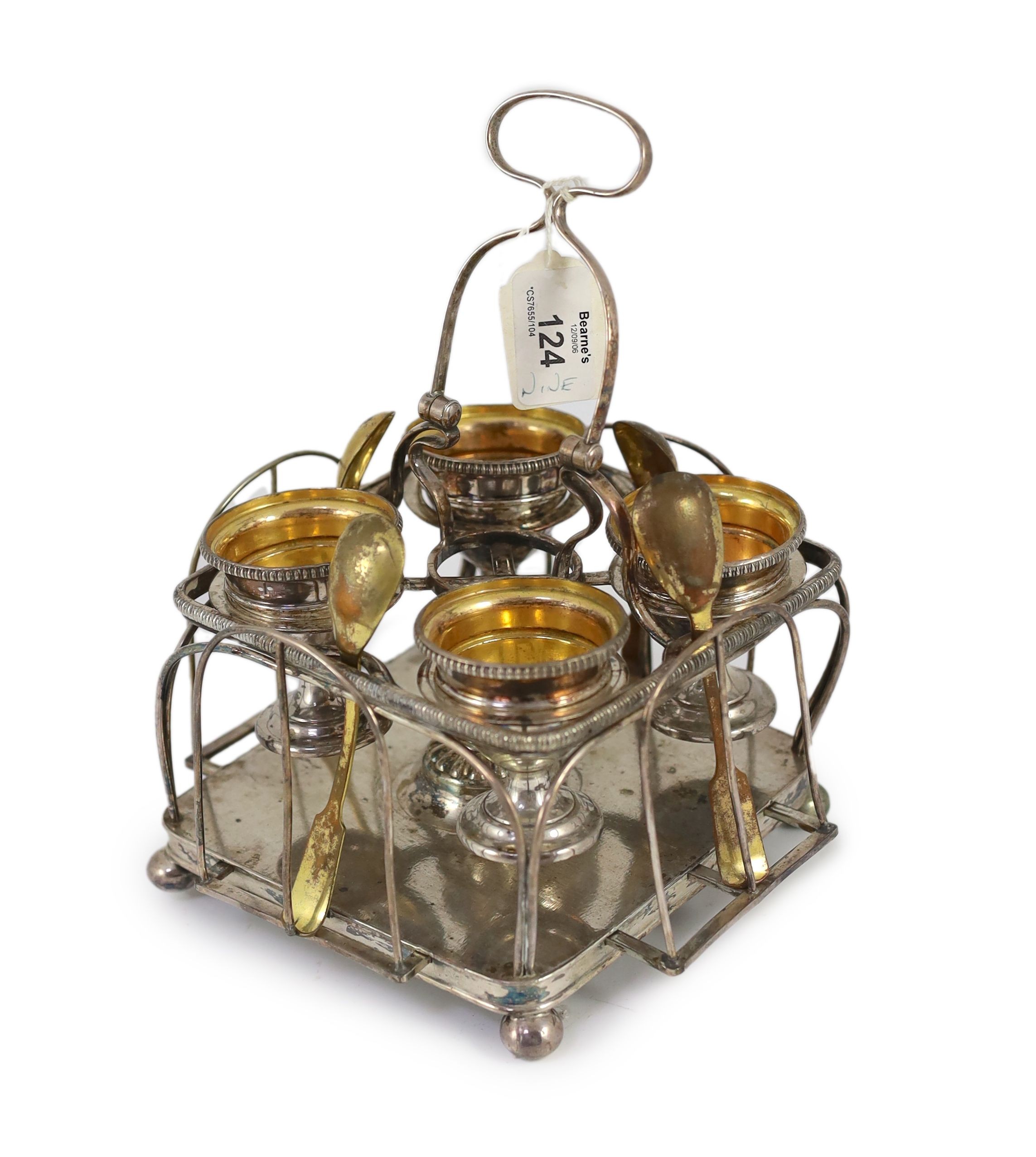 A Sheffield plate egg cruet with four egg cups and spoons,the square frame with gadroon borders