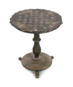 A Victorian papier mache and ebonised wood pedestal games table,with shaped circular top inlaid with