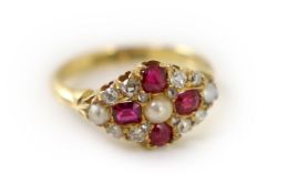 An early 20th century 18ct gold, ruby, diamond and split pearl cluster set dress ring,size K,