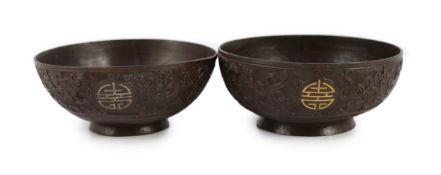 A pair of Chinese coconut bowls, 19th century,each carved in relief with the symbols of the eight