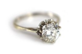 A Continental white gold and solitaire diamond set ring,in a raised setting, the stone weighing