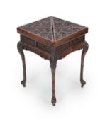 A Chinese hongmu ‘dragon’ envelope card table, c.1910,the quartered folding top carved in high