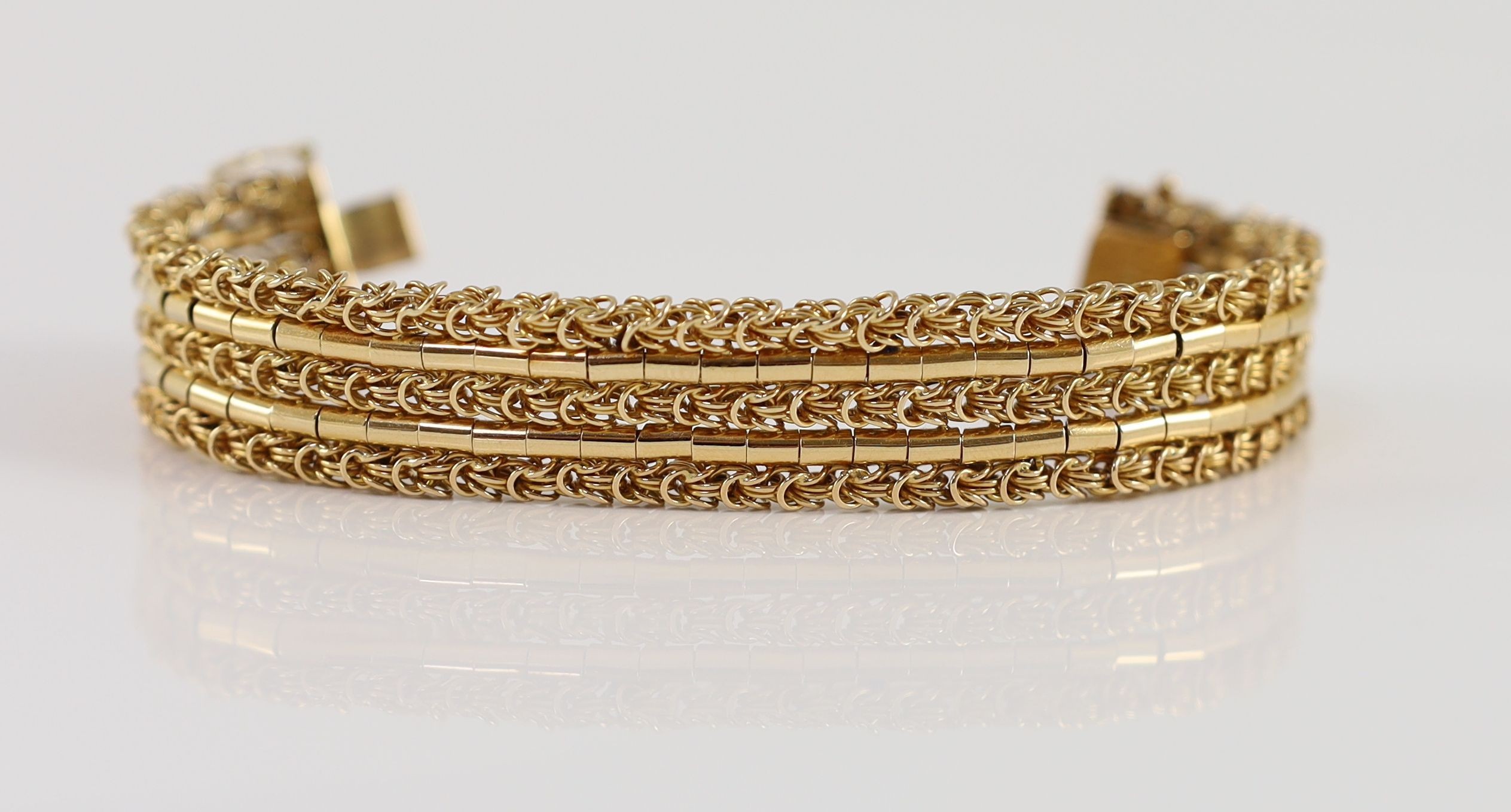 A 20th century 18k gold interwoven three row bracelet,with safety chain. interior length approx. - Image 2 of 3