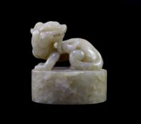 A Chinese celadon and white mottled jade ‘lion-dog’ seal, 18th/19th century,the beast sitting upon